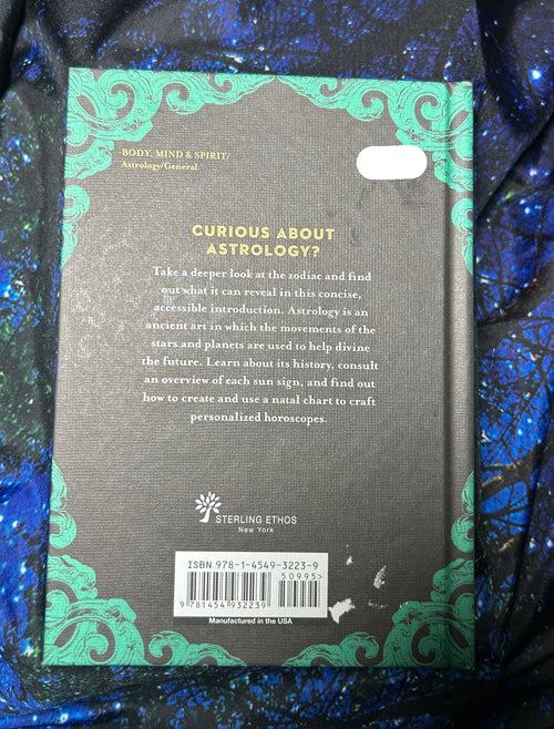Back cover of a book with astrological text and design elements on a blue textured background